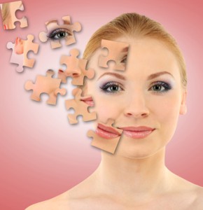 Beautiful girl with parts of skin on puzzles on pink background